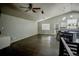Spacious living room with wood floors, light walls, and open flow to the kitchen at 11384 Oakland Dr, Commerce City, CO 80640