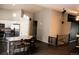 Open-concept living room adjacent to kitchen features hardwood floors and vaulted ceilings for a spacious feel at 11384 Oakland Dr, Commerce City, CO 80640