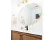 Stylish bathroom with a round mirror, modern sink, and woven wood vanity at 1543 S Ouray Cir # B, Aurora, CO 80017