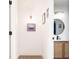 Modern bathroom features a round mirror, sconce lighting, and a stylish vanity with a woven wood cabinet at 1543 S Ouray Cir # B, Aurora, CO 80017