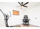Bright bedroom features a ceiling fan, a desk, and an elliptical machine, perfect for a home office and workout space at 1543 S Ouray Cir # B, Aurora, CO 80017