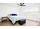 Bedroom with ceiling fan, hardwood floors, two windows, and patterned bedding on the bed at 1543 S Ouray Cir # B, Aurora, CO 80017