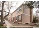 A tan two-story townhome with brick accents and a sidewalk leads to the front door at 1543 S Ouray Cir # B, Aurora, CO 80017