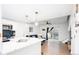 Open-concept kitchen flows into the living area, featuring a breakfast bar, stainless appliances, and modern lighting at 1543 S Ouray Cir # B, Aurora, CO 80017