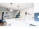 The kitchen has marble counters, stainless steel appliances, and modern lighting, with stairs in the background at 1543 S Ouray Cir # B, Aurora, CO 80017