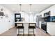 Charming kitchen with stainless appliances, breakfast bar, and a classic black door at 1543 S Ouray Cir # B, Aurora, CO 80017