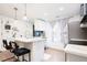 Well-lit kitchen with white cabinets, stainless appliances, and a stylish breakfast bar at 1543 S Ouray Cir # B, Aurora, CO 80017