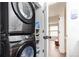 Efficient laundry area with a stacked washer and dryer, plus shelving for convenient storage of supplies at 1543 S Ouray Cir # B, Aurora, CO 80017
