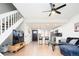 Open concept living room with laminate flooring, kitchen, and staircase at 1543 S Ouray Cir # B, Aurora, CO 80017