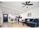 Open concept living room with kitchen, laminate flooring, and comfortable seating at 1543 S Ouray Cir # B, Aurora, CO 80017