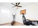Office with hardwood floors, ceiling fan, a window, an elliptical machine, and a desk with a chair at 1543 S Ouray Cir # B, Aurora, CO 80017