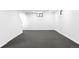 Spacious carpeted basement with white painted walls and a bright window at 7603 W Coal Mine Pl, Littleton, CO 80128