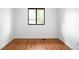Simple bedroom featuring hardwood floors and a bright window at 7603 W Coal Mine Pl, Littleton, CO 80128