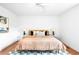 Bright bedroom featuring hardwood floors, white walls, ceiling fan, and stylish decor at 7603 W Coal Mine Pl, Littleton, CO 80128