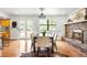 Bright dining room featuring hardwood floors, modern chandelier, fireplace, and large window to view outdoors at 7603 W Coal Mine Pl, Littleton, CO 80128