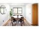 Cozy dining area with a round table, seating for four, and a large window providing ample natural light at 7603 W Coal Mine Pl, Littleton, CO 80128