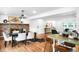 Elegant dining area with a brick fireplace, seating for six, and an open layout connecting to the living space at 7603 W Coal Mine Pl, Littleton, CO 80128