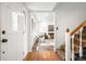 Bright and airy foyer with hardwood floors, staircase, and view into the inviting living room with a modern design at 7603 W Coal Mine Pl, Littleton, CO 80128