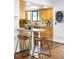 Kitchen with wood cabinets, bar-stool seating, and a window overlooking the outdoors at 7603 W Coal Mine Pl, Littleton, CO 80128