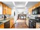 Open concept kitchen leading to a dining area with an island and a view of the living space, perfect for gatherings at 7603 W Coal Mine Pl, Littleton, CO 80128