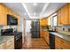 Spacious kitchen featuring wood cabinets, modern appliances, and plenty of counter space for cooking and meal preparation at 7603 W Coal Mine Pl, Littleton, CO 80128