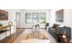 Modern living room featuring hardwood floors, large windows, neutral color palette, and stylish furniture, enhancing the space at 7603 W Coal Mine Pl, Littleton, CO 80128