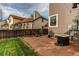 Outdoor space with a hot tub and brick patio, offering a relaxing backyard retreat at 4889 S Elkhart Ct, Aurora, CO 80015