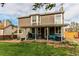 Spacious backyard featuring a covered patio with outdoor furniture and a well-maintained lawn at 4889 S Elkhart Ct, Aurora, CO 80015
