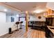 Finished basement features wood floors, bar seating, and a comfortable entertainment area at 4889 S Elkhart Ct, Aurora, CO 80015