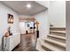 Finished basement with a wet bar, carpeted stairs, and storage at 4889 S Elkhart Ct, Aurora, CO 80015