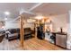Finished basement includes comfortable seating and a convenient wet bar with a refrigerator at 4889 S Elkhart Ct, Aurora, CO 80015