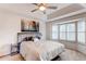 Bedroom features a large bed, bay window, and decorative wall art at 4889 S Elkhart Ct, Aurora, CO 80015