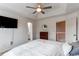 Bright bedroom with tray ceiling and open doors to landing and bath at 4889 S Elkhart Ct, Aurora, CO 80015