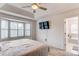 Bright bedroom featuring a large window, and en suite bath at 4889 S Elkhart Ct, Aurora, CO 80015