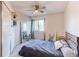 Cozy bedroom with ceiling fan, side shelves, and a window view at 4889 S Elkhart Ct, Aurora, CO 80015