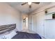 Bedroom featuring a closet with sliding doors and adjacent shelves at 4889 S Elkhart Ct, Aurora, CO 80015