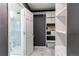 Well-organized walk-in closet with custom shelving and an attached shower room at 4889 S Elkhart Ct, Aurora, CO 80015