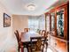 Elegant dining room with a large wood table and china cabinet at 4889 S Elkhart Ct, Aurora, CO 80015