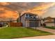 Beautiful home with a well-maintained lawn, a two-car garage, and basketball hoop on a sunny day at 4889 S Elkhart Ct, Aurora, CO 80015