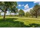 Park-like setting with mature trees, grassy expanse and walking path at 4889 S Elkhart Ct, Aurora, CO 80015