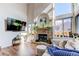 Bright living room featuring a fireplace, tall ceilings, and large windows at 4889 S Elkhart Ct, Aurora, CO 80015
