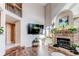 Bright living room featuring a fireplace, tall ceilings, and large windows at 4889 S Elkhart Ct, Aurora, CO 80015