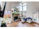Bright living room with a brick fireplace and large windows at 4889 S Elkhart Ct, Aurora, CO 80015