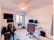 Functional office with a ceiling fan, mounted TV, and modern desk setup at 4889 S Elkhart Ct, Aurora, CO 80015