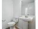 Bright bathroom with a pedestal sink and a separate toilet room at 2116 Chambers Rd, Brighton, CO 80601