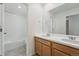 Bathroom featuring double sinks and a shower-tub combo with tile surround at 2116 Chambers Rd, Brighton, CO 80601