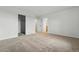 Spacious bedroom with neutral carpet, white walls, and several doors at 2116 Chambers Rd, Brighton, CO 80601