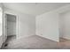 This is a secondary bedroom with neutral carpet, white walls, and a closet at 2116 Chambers Rd, Brighton, CO 80601