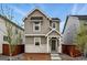 Charming two-story home with wood and stone accents, a welcoming front porch, and well-maintained landscaping at 2116 Chambers Rd, Brighton, CO 80601