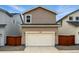 The home's exterior includes a white garage door and a small wooden fence at 2116 Chambers Rd, Brighton, CO 80601